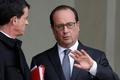 Francouzský prezident Francois Hollande (vpravo) mluví s premiérem Manuelem Vallsem