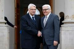 Polish Foreign Minister Waszczykowski shakes hands with his German counterpart Steinmeier at the Lazienki Palace in Warsaw