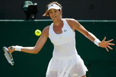 Garbine Muguruza of Spain hits a shot during her match against Angelique Kerber of Germany at the Wimbledon Tennis Championships in London