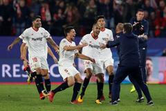 Fotbalisté Sevilly se běží podělit s trenérem Eduardem Berizzem o radost z gólu proti Liverpoolu