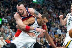 Marcin Gortat z Washingtonu atakuje Rudyho Goberta v utkání, které Utah vyhrál vysoko 116:69