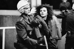 Studentka uvězněná v objetí policisty. Ikonickou fotografii sametové revoluce zachytil Herbert Slavík už 28. října.