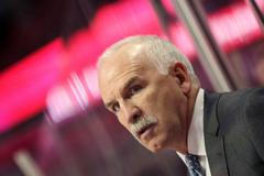 Blackhawks head coach Quenneville directs his team against t