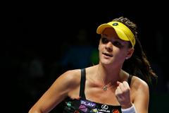 Radwanska of Poland celebrates her win over Kvitova of the Czech Republic during their WTA Finals singles tennis match at the Singapore Indoor Stadium