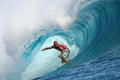 FILE PHOTO: Surfer Slater of the U.S rides a wave during the third round of competition in the Billabong Pro surfing tournament on the legendary reef break in Teahupoo