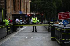 Britský policista u budovy parlamentu v Londýně poté, co Salih Khater najel do skupiny cyklistů.