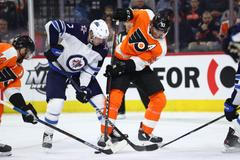 Jakub Voráček (93) z Philadelphie a hráč Winnipegu Dmitrij Kulikov v zápase NHL.