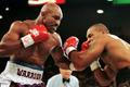 FILE PHOTO: WBA Heavyweight Champion Evander Holyfield (R) connects to the jaw of challenger Mike Tyson in the f..