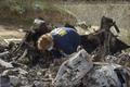 An investigator works at the site of the helicopter crash that killed Kobe Bryant and eight others in a screen grab taken in Calabasas