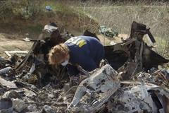 An investigator works at the site of the helicopter crash that killed Kobe Bryant and eight others in a screen grab taken in Calabasas