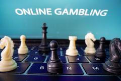 Chess are placed on the keyboard in front of displayed "Online Gambling" words in this illustration picture