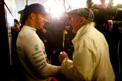 Mercedes Formula One driver Hamilton of Britain chats with three time retired world champion Stewart of Britain after Hamilton won the U.S. F1 Grand Prix at the Circuit of The Americas in Austin