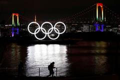 The giant Olympic rings are illuminated after being reinstalled at Odaiba Marine Park, amid the coronavirus disease (COVID 19) outbreak, in Tokyo