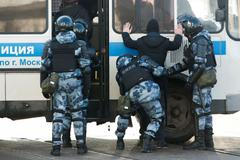 Policisté zatýkají lidi před budovou, kde se odehrává soud s Alexejem Navalným.