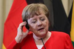 German Chancellor Angela Merkel gestures during a media briefing at the Union Buildings in Pretoria