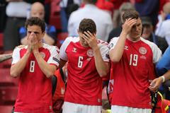 Zdrcení dánští hráči sledují boj o život Christiana Eriksena v zápase Dánsko - Finsko na ME 2020