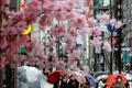 FILE PHOTO: Pedestrians wearing protective face masks walk at a shopping district in Tokyo