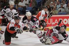 NHL Buffalo Sabres defenseman Alexei Zhitnik (44) flies to defend against Philadelphia Flyers left wing John LeClair, left, as goalie Dominik Hasek, right, covers the net in the third period