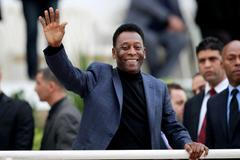 FILE PHOTO: Brazilian soccer legend Pele waves during the international friendly soccer match between Algeria and Slovenia in Algiers
