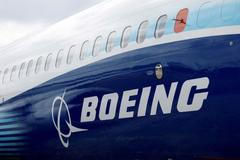 FILE PHOTO: The Boeing logo is seen on the side of a Boeing 737 MAX at the Farnborough International Airshow