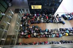 FILE PHOTO: Lines of passenger luggage lie arranged outside Terminal 2 at Heathrow Airport in London
