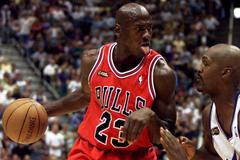 FILE PHOTO: Chicago Bulls guard Michael Jordan of the defending NBA champion Chicago Bulls drives to the hoop ag..