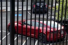 A Tesla vehicle is parked on West Executive Avenue near the White House in Washington
