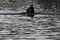 A man drinks a water as he rows a boat on the Vltava river in Prague