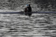 A man drinks a water as he rows a boat on the Vltava river in Prague