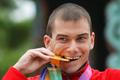 FILE PHOTO: Bakulin of Russia bites his gold medal after the men's 50 km race walk final at the IAAF World Athletics Championships in Daegu