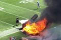 People try and extinguish fire from burning equipment used during pregame, du