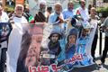 Demonstrators hold a poster during a protest in solidarity with journalists in Gaza, in Sidon