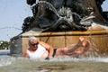 A woman lies in the water of the Fontaine des Trois Graces, in Bordeaux