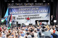 People attend a rally protesting for peace in Gaza, in Berlin