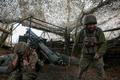 FILE PHOTO: Ukrainian servicemen fire a self-propelled howitzer towards Russian troops near the frontline town of Pokrovsk
