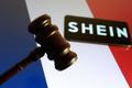 Illustration shows Shein logo, court gavel and France flag