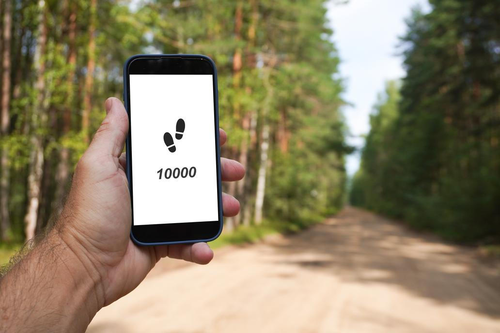 Hand,Holding,Smartphone,Displaying,10000,Steps,Counter,App,In,A
