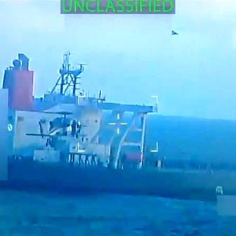 U.S. military helicopter flies near an oil tanker during its seizure by the United States off the coast of Venezuela