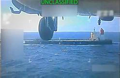 U.S. military helicopter flies near an oil tanker during its seizure by the United States off the coast of Venezuela