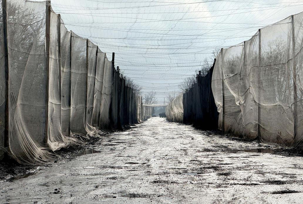 Anti-drone nets erected over a road near the frontline city of Kupiansk