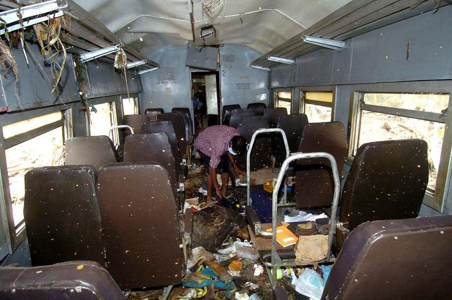 Železniční pracovník odklízí trosky z vykolejovaného vagonu vlaku Královna moře. Sinigama u Hikkaduwy, Srí Lanka, 8. ledna 2005.