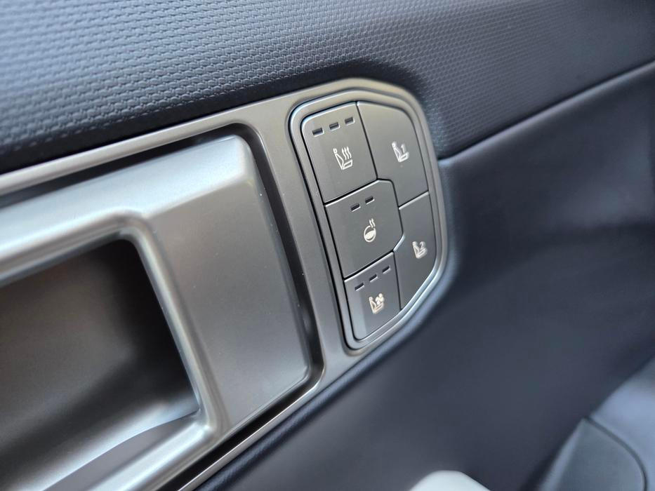 Ovládání výhřevu volantu i předních sedadel, respektive ventilace sedadel je ve dveřích.