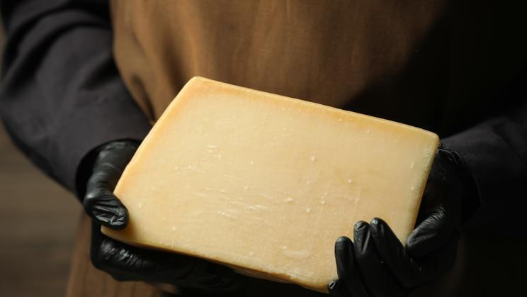 Woman,With,Piece,Of,Delicious,Cheese,,Closeup