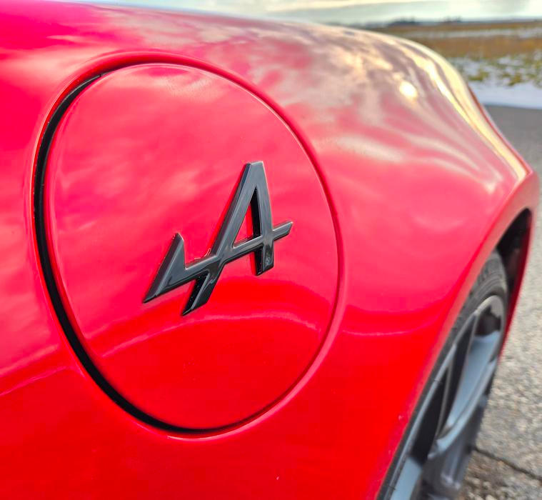 Na předních blatnících jsou loga Alpine...