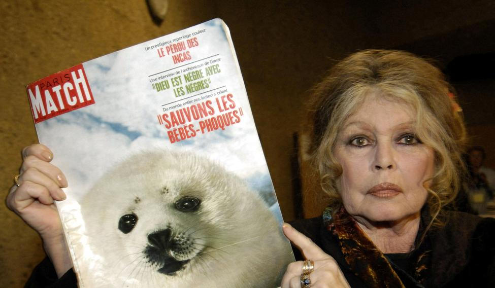 FILE PHOTO: Former French actress Brigitte Bardot displays a 1969 copy of french magazine "Paris Match" showing ..