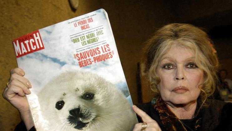 FILE PHOTO: Former French actress Brigitte Bardot displays a 1969 copy of french magazine "Paris Match" showing ..