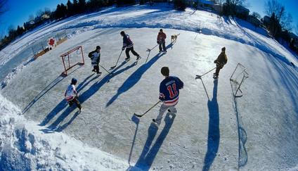 Boys playing hockey on outdoor rink, Winnipeg, Manitoba, Canada.