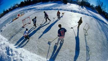 Boys playing hockey on outdoor rink, Winnipeg, Manitoba, Canada.