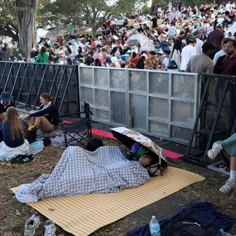 People sleep at Mrs Macquaries Point ahead of New Year's Eve fireworks, in Sydney