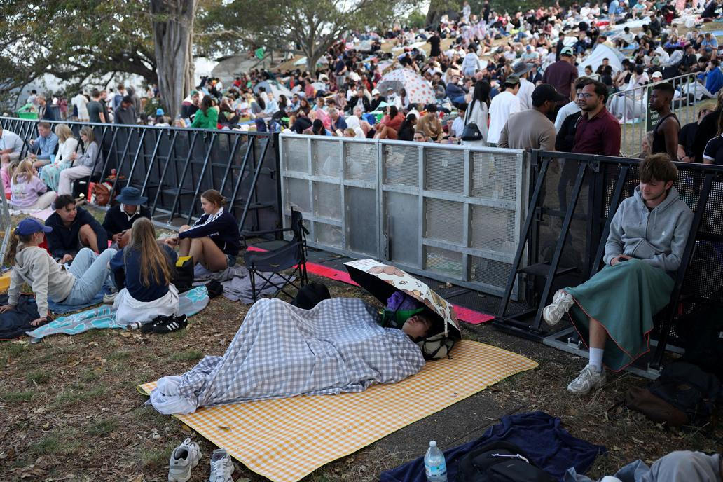 People sleep at Mrs Macquaries Point ahead of New Year's Eve fireworks, in Sydney